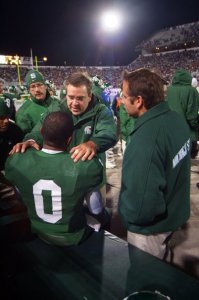 Dr. Randy Pearson consults on the Spartan sideline