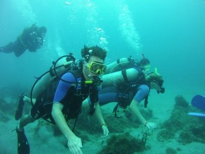 Divers by Coral Reef in West Indies