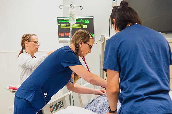 Nurses working with doctor in a patient room