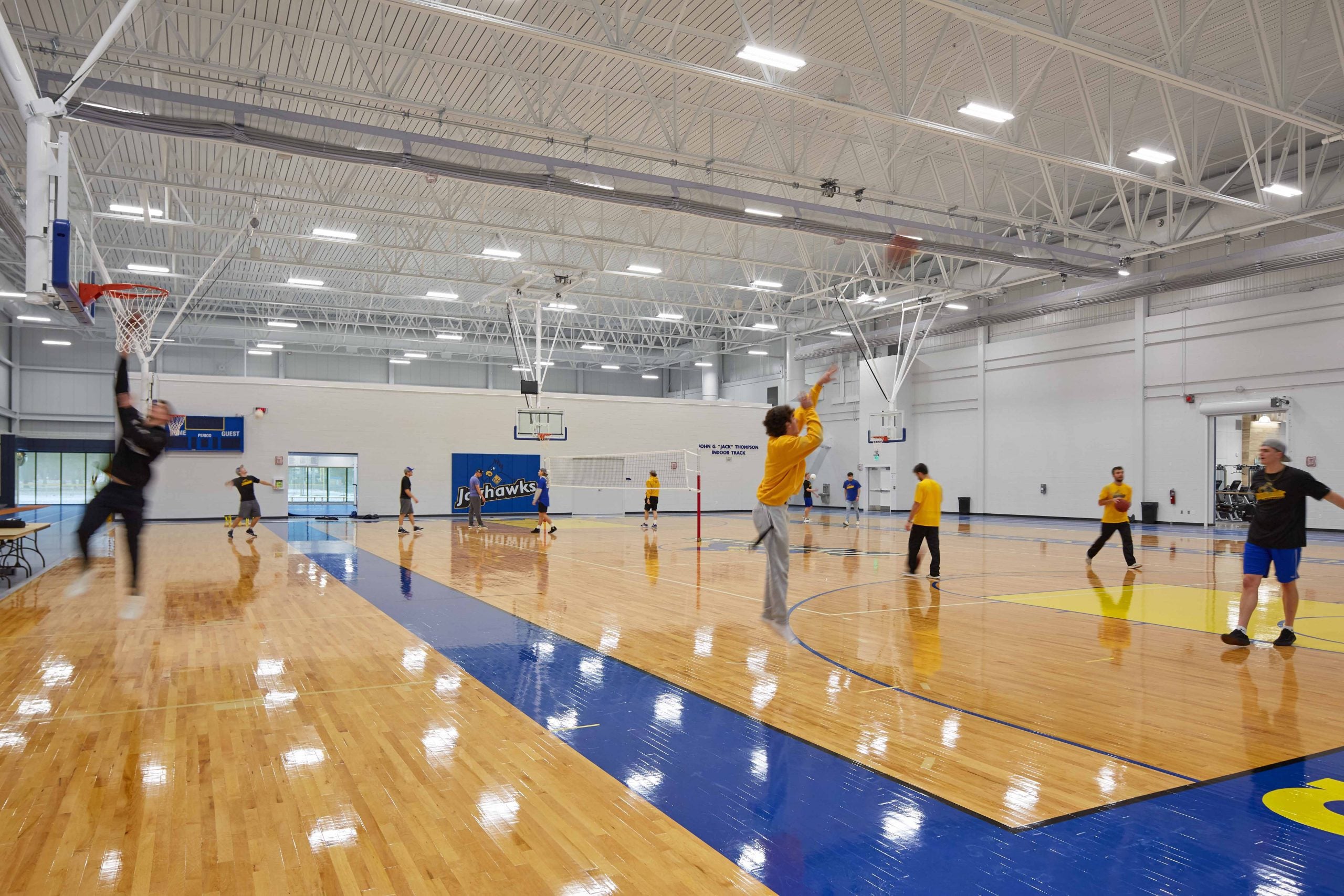 MCC's Health and Wellness Basketball Court, players are shooting basketballs and playing around.