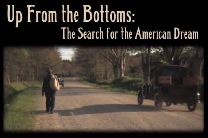 Picture of a young African America walking on an old road with a model-T car driving by.