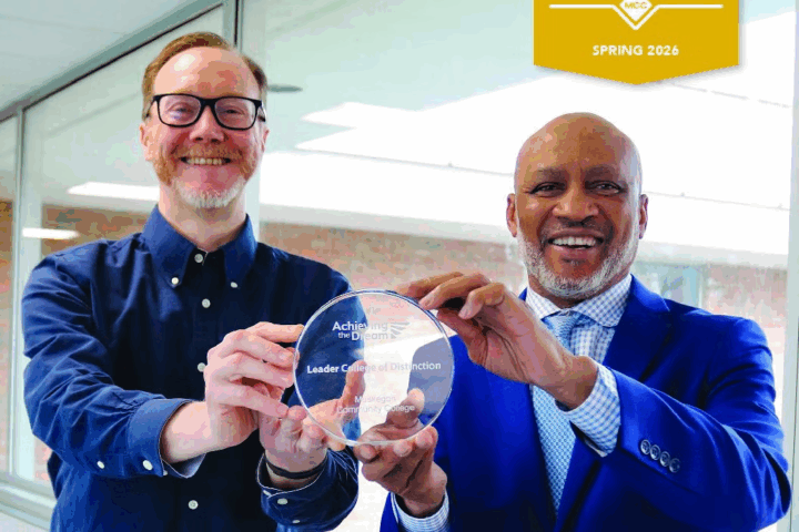 President John Selmon and Provost Tucker Brown both hold Acheving the Dream award Tucker Brown hold an award together and smile for the camera.